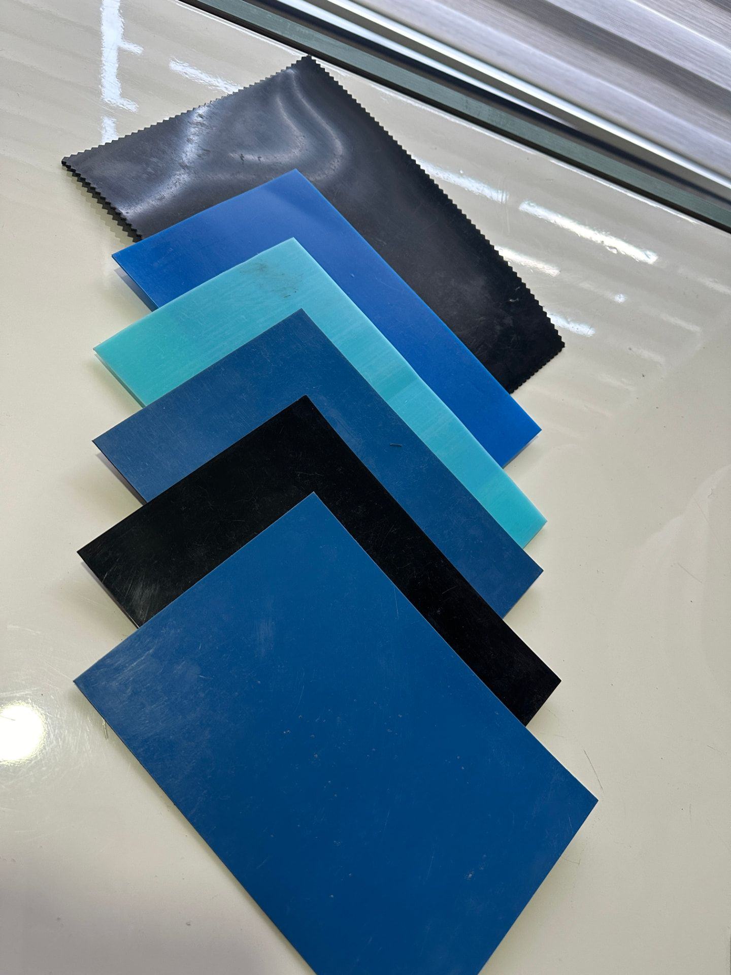 EPDM liner samples in black, deep blue, mid blue and turquoise