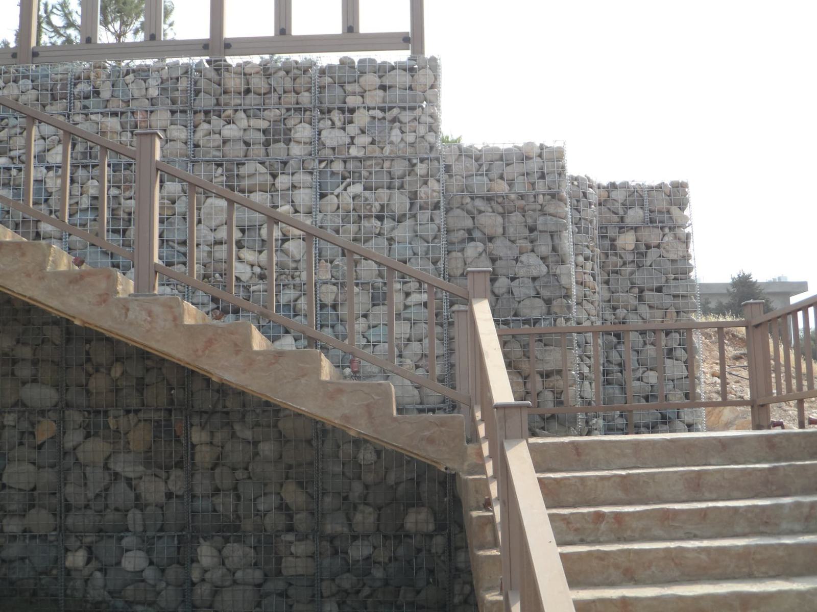 Gabion stone wall beside outdoor stairs